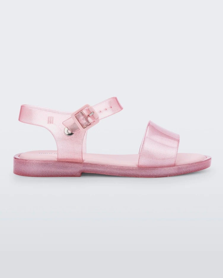 Side view of a pink glitter Mini Melissa Mar Sandal.