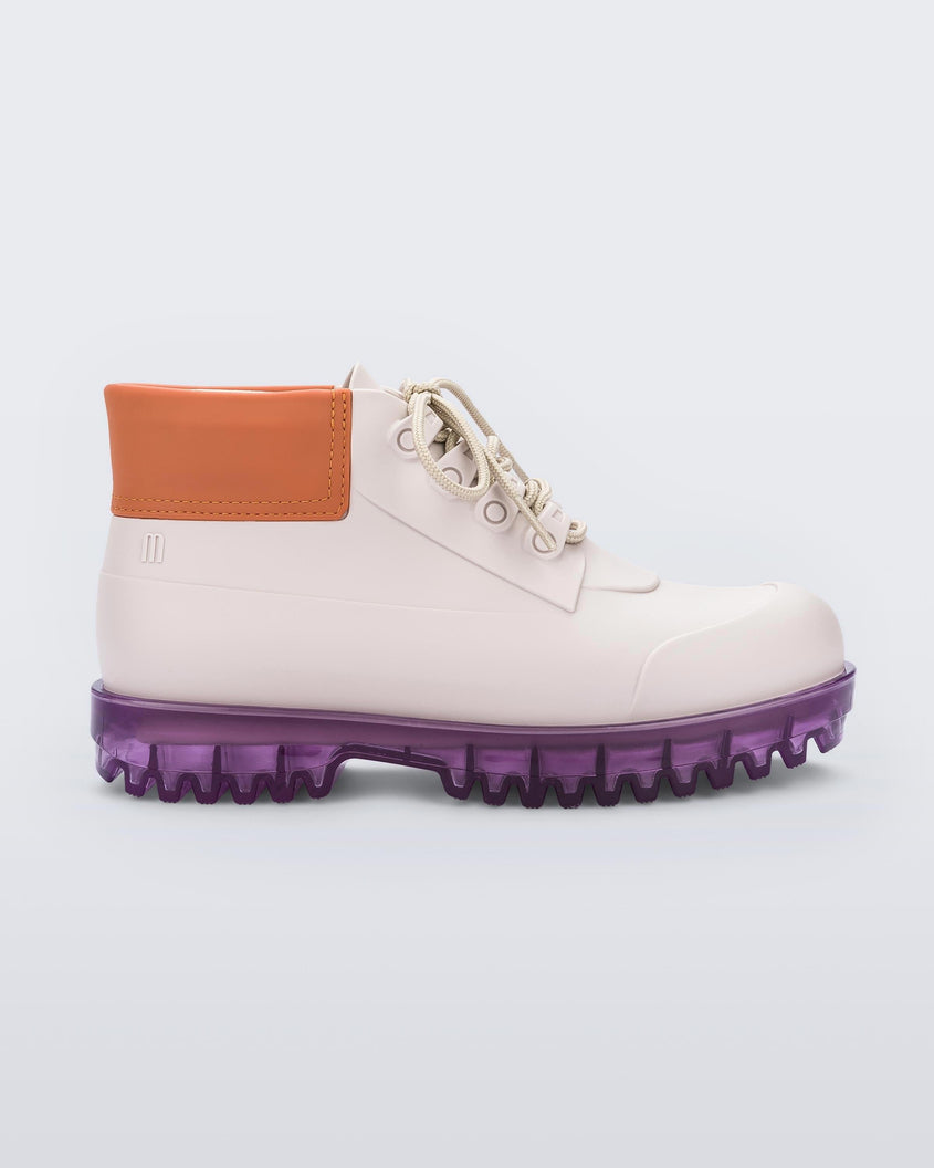 Side view of a pair of beige/orange/lilac Melissa Ares combat boots with a beige base, beige laces, orange top back and translucent lilac sole.