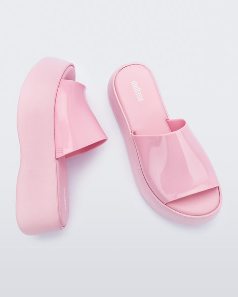 Top and side view of a pair of pink Melissa Becky platform slides.
