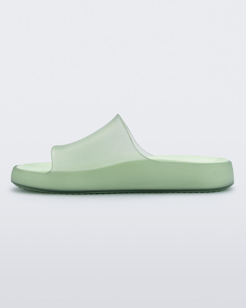 An inner side view of a transparent green Melissa Cloud slide.