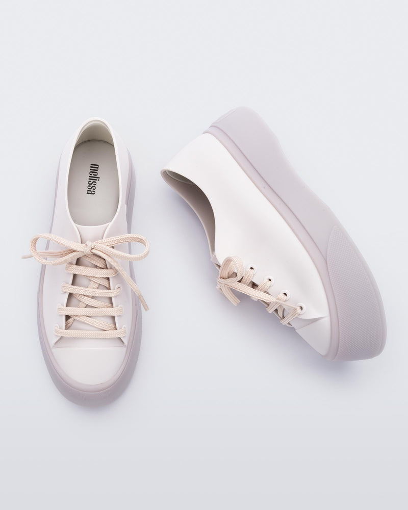 Top and side view of a beige Drive sneaker
