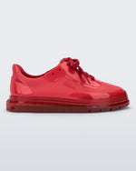 Side view of a red Melissa Classic sneaker with a red base, laces, sole and a melissa logo on the side
