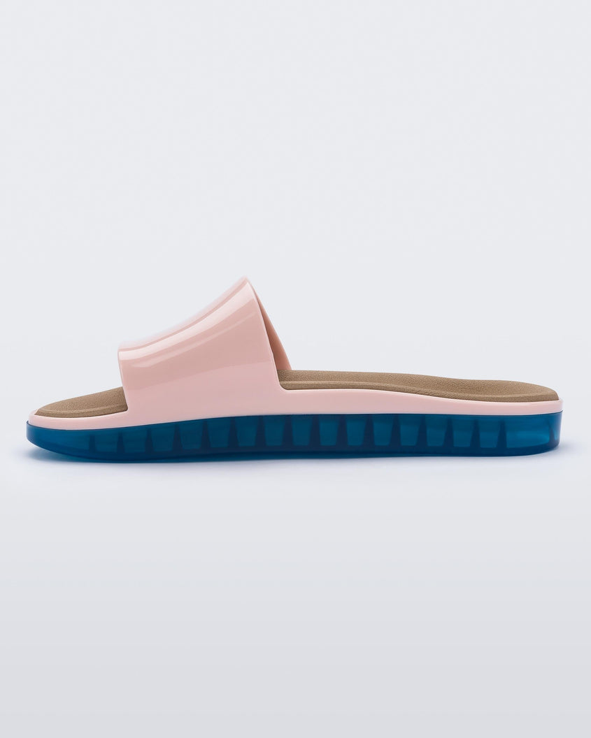 Inside view of a pink Melissa Beach slide with blue sole.