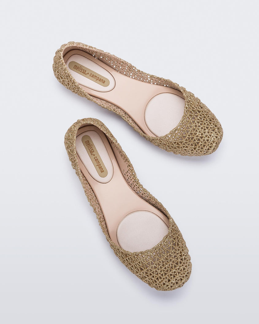 A model's legs wearing a pair of pink Melissa Campana ballet flats.