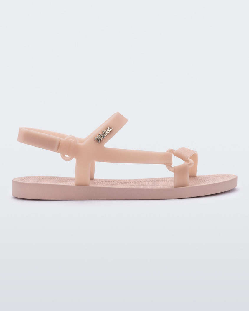 Side view of a Melissa Sun Downtown sandal with pink front cross and back ankle straps and a pink sole.