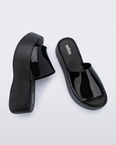 Top and side view of a pair of black Melissa Becky platform slides.