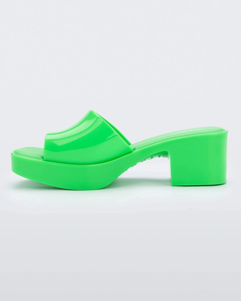 Inner side view of a Melissa Shape platform slide in Green.