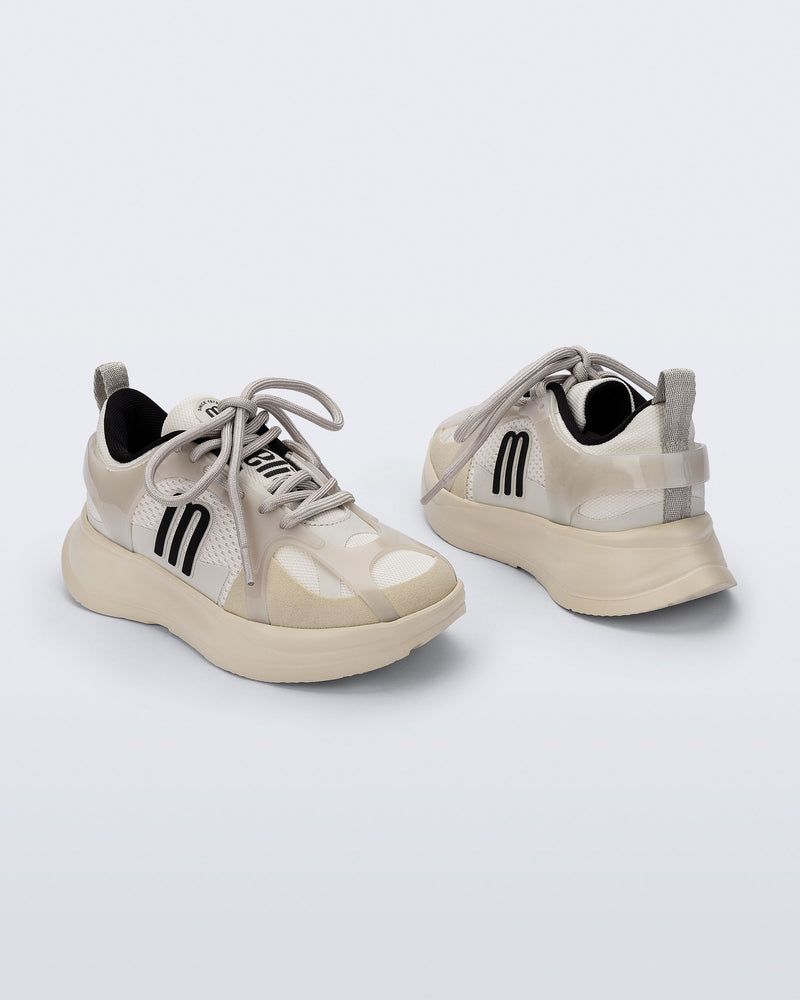 Back and angled view of a pair of off white X Beat kids sneakers with black trim