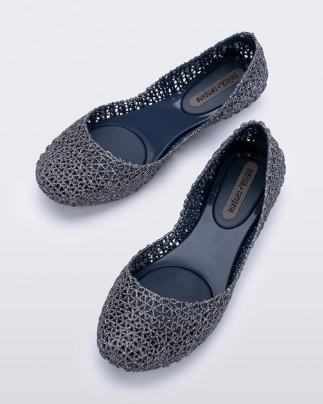 Top angled view of a pair of blue/glitter Campana flats
