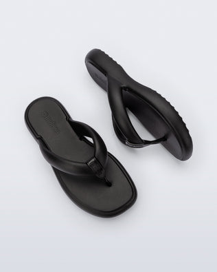 Side and top view of a pair of black Free Low flip flops