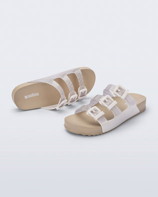 Top and angled view of a pair of beige Cozy Stripes sandals with white upper with 3 buckles