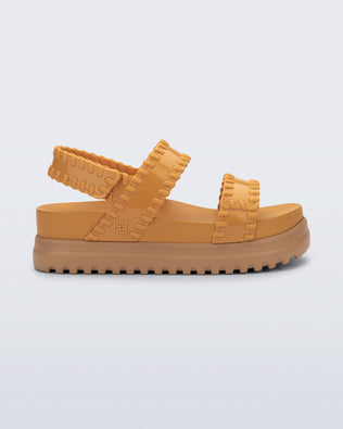 Side view of a orange Dune Platform Sandal with faux stitching on the straps and beige sole