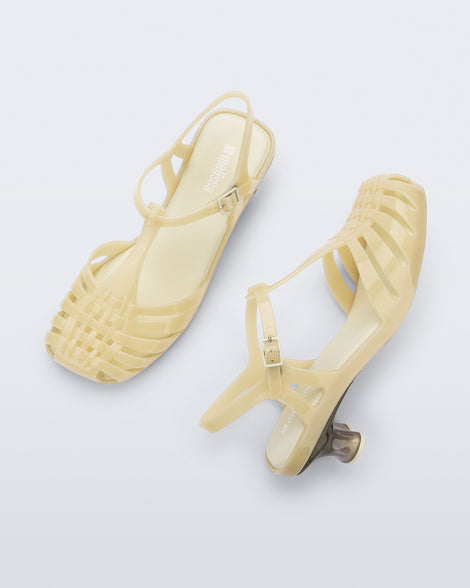 Top and side view of a pair of milky beige Vixen Kitten Heel sandals