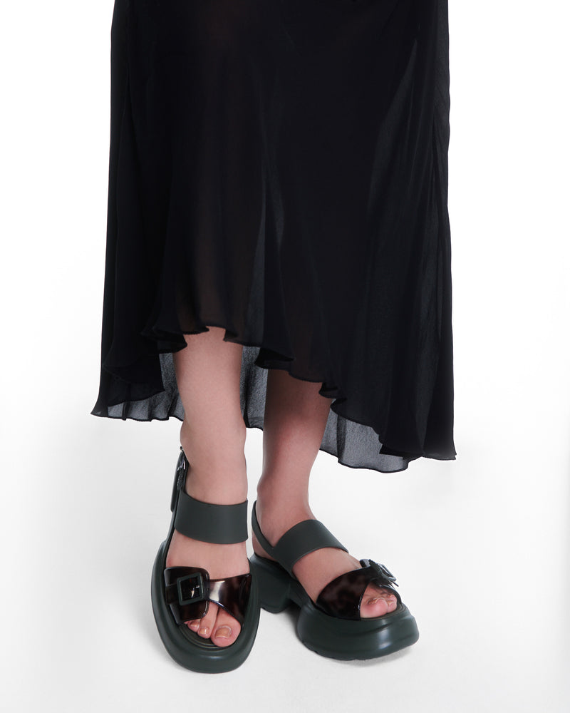 Model's legs wearing pair of green Push platform Sandals