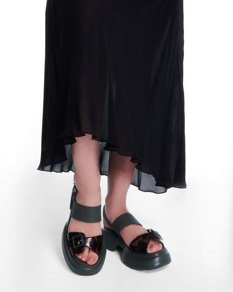 Model's legs wearing pair of green Push platform Sandals