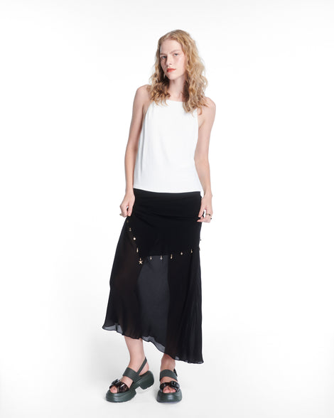 Model in white top and black skirt wearing pair of green Push platform Sandals