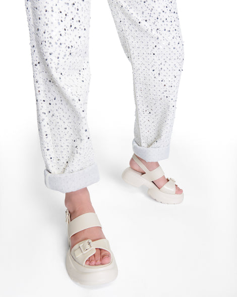Model's legs wearing pair of beige Push platform Sandals