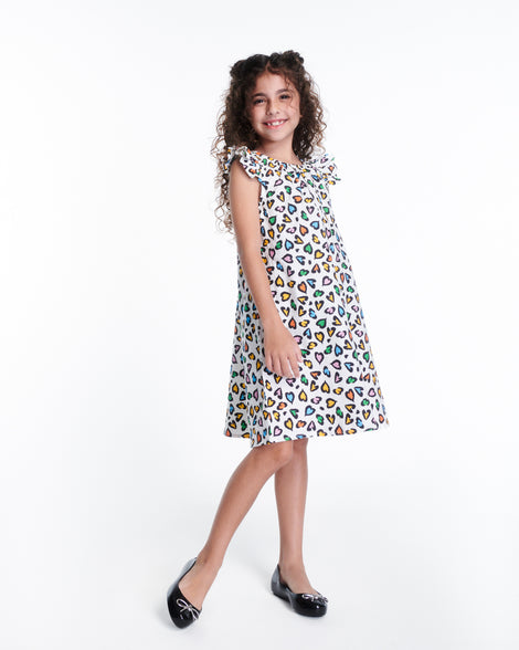 Child model in a dress wearing a pair of black Sweet Love Chrome kids flats with metallic silver bow