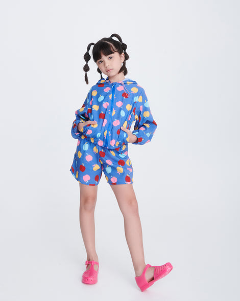 Child model in blue shorts and shirt wearing a pair of pink Aranha 79 kids flats with buckle