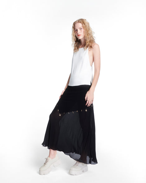 Model in a black skirt and whit top wearing a pair of beige Camp platform Sneakers with beige laces
