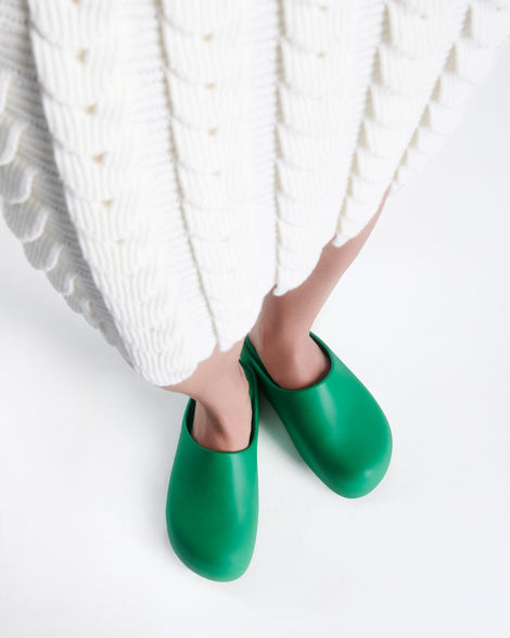 Model's legs wearing a pair of green Free Clog Up Platforms