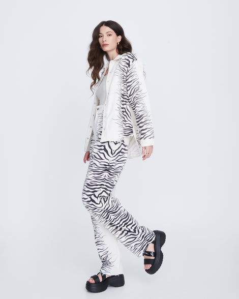 Model in a zebra print pant set wearing a pair of black Stand platform sandals