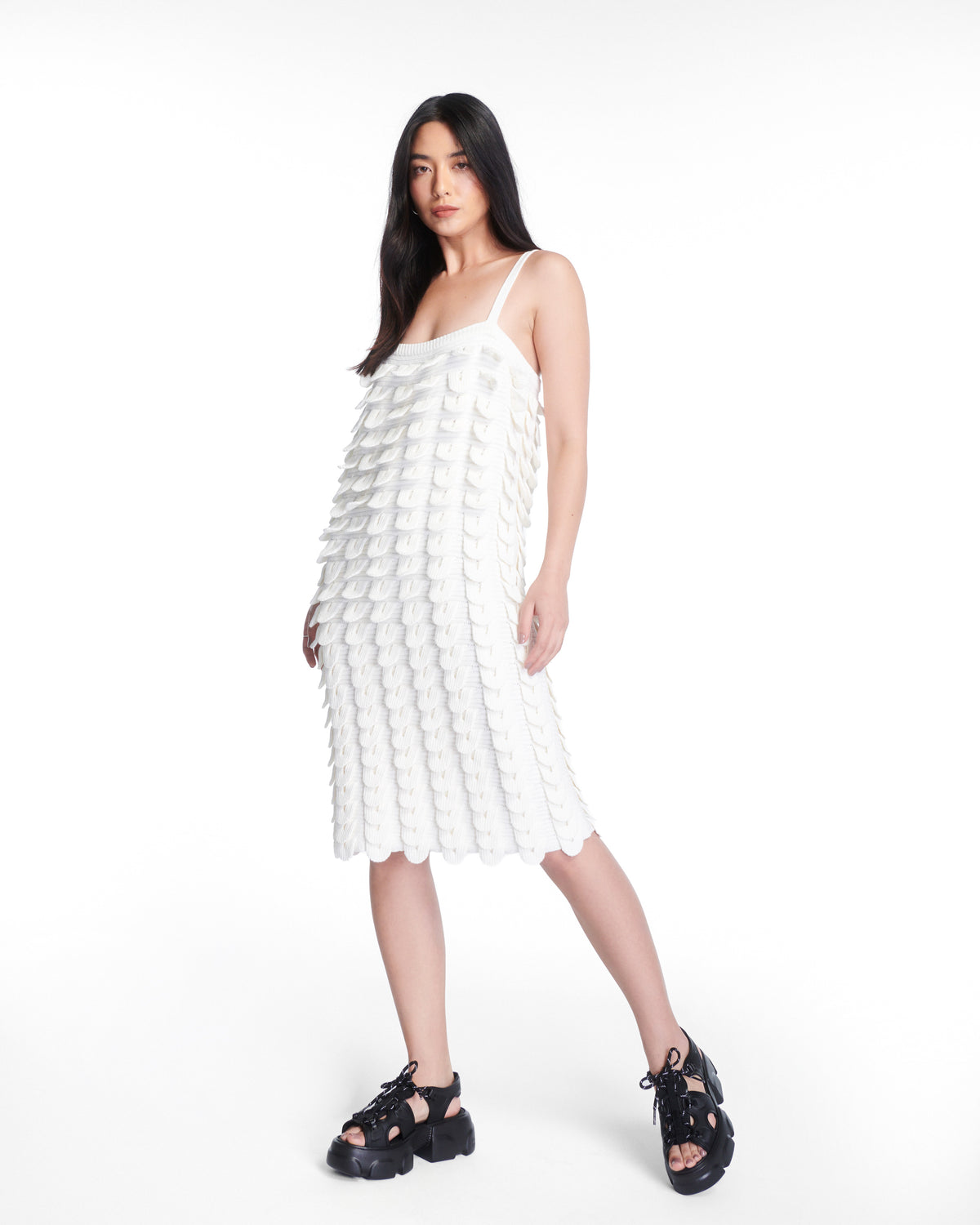 Model in a white dress wearing a pair of black Camp platform sandals with black laces