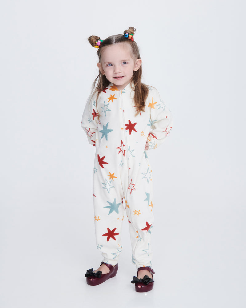 Child model in a one piece white outfit wearing a pair of burgundy Ultragirl Classy baby flats with black bow