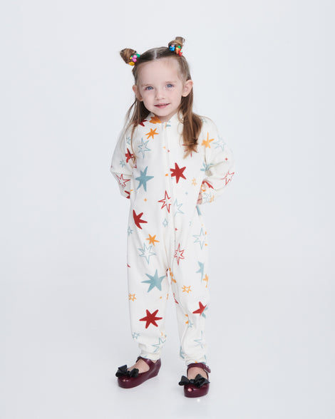 Child model in a one piece white outfit wearing a pair of burgundy Ultragirl Classy baby flats with black bow