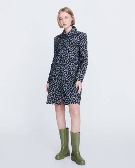 Model in a black and blue dress wearing a pair of army green Welly rain boots