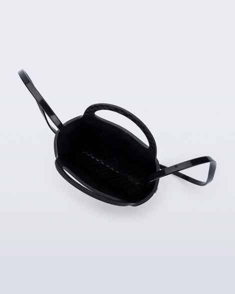 Top view of a black Ultra Bag with handle and strap