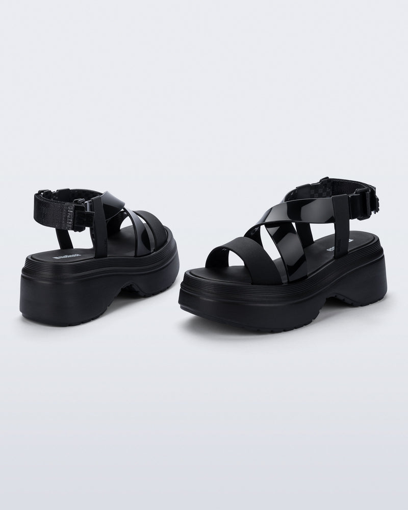 back and angled view of a pair of black Stand platform sandals