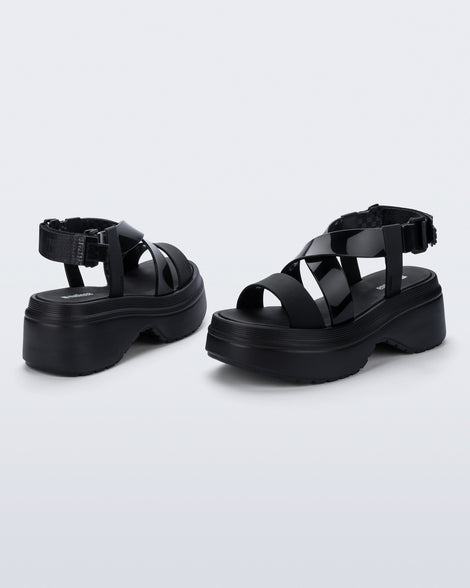 back and angled view of a pair of black Stand platform sandals