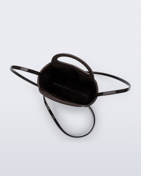 Top view of a brown Ultra Bag with handle and strap