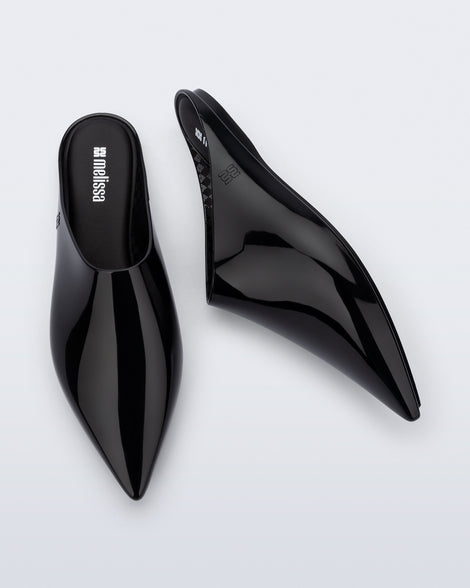 Top and side view of a pair of black She slip ons with pointed toe