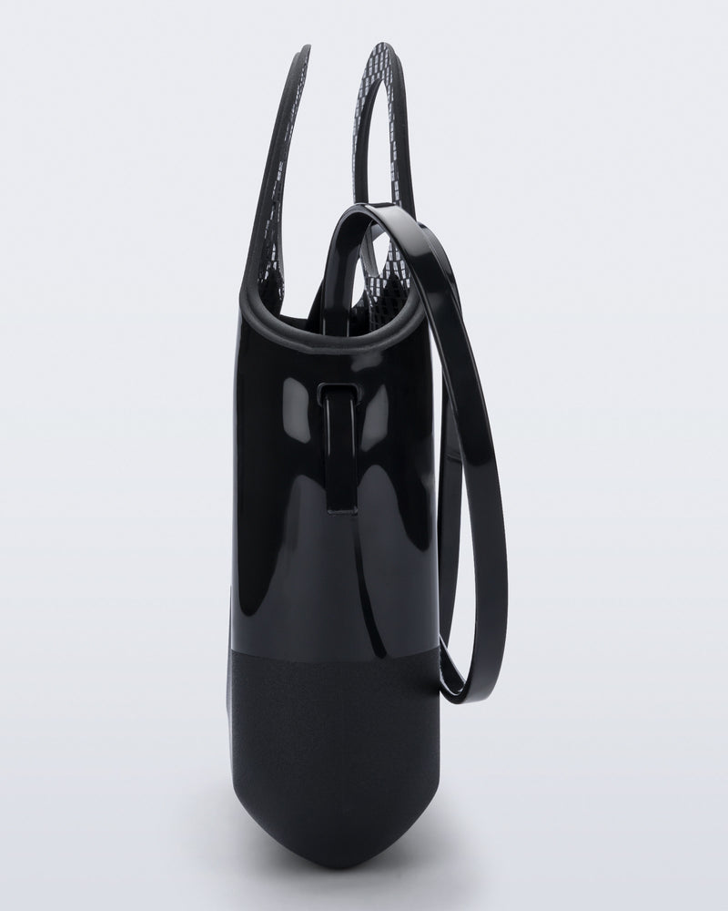 Back view of a black Ultra Bag with handle and strap