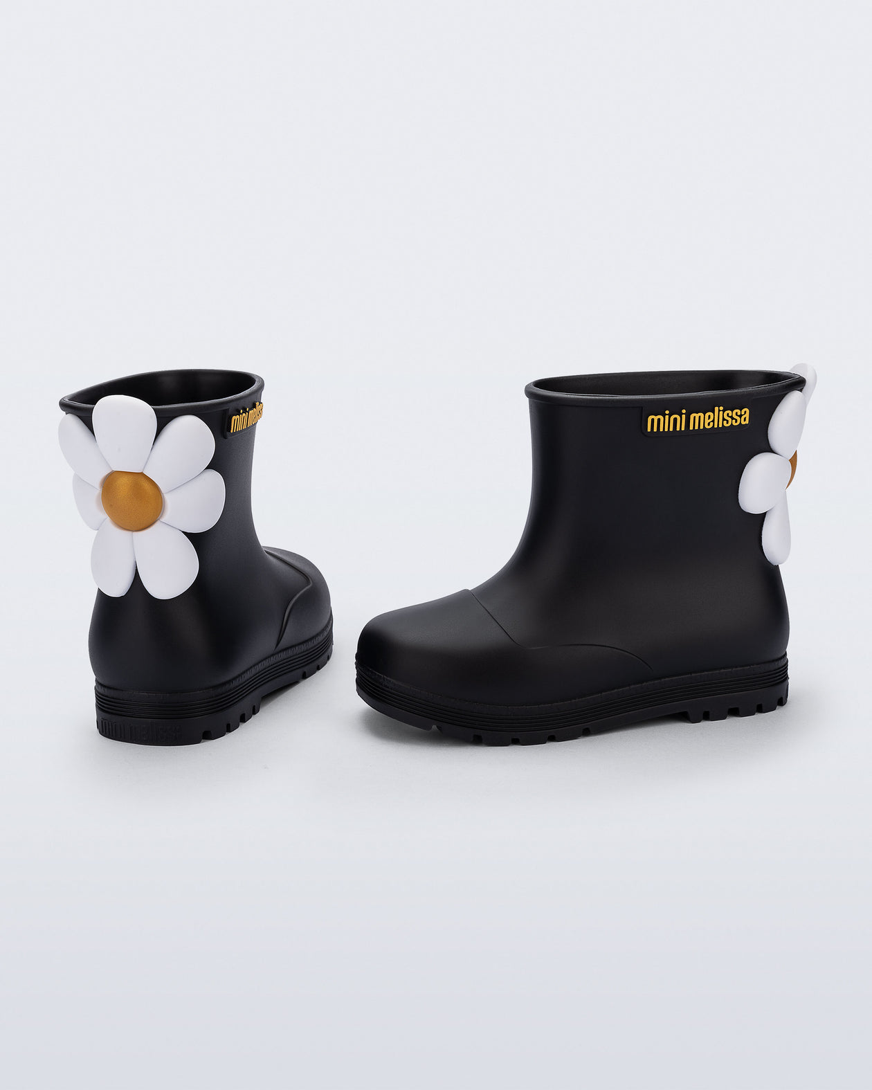 Side and back view of a pair of black Welly Bloomy boots with white daisy on back