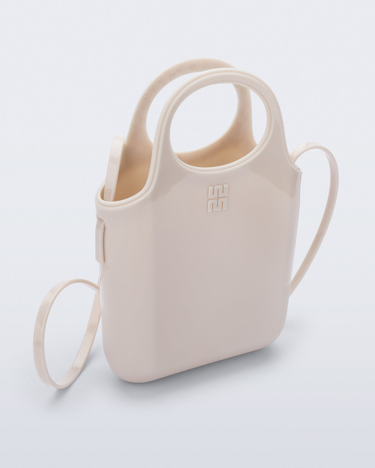Angled view of a beige Ultra Bag with handle and strap with bag dimensions of 15cm x 5cm x 15cm