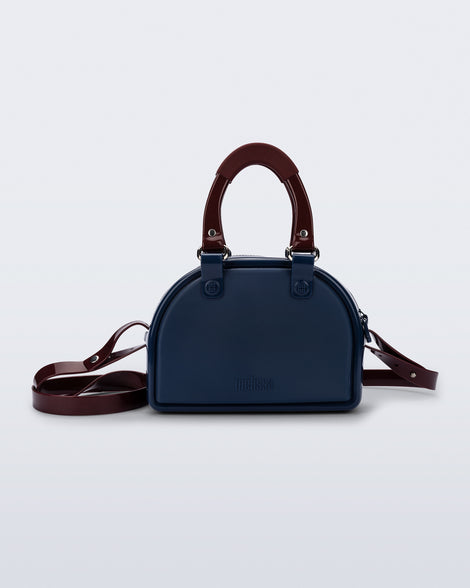 Front view of a blue Bowling bag with burgundy handle strap and cross body strap