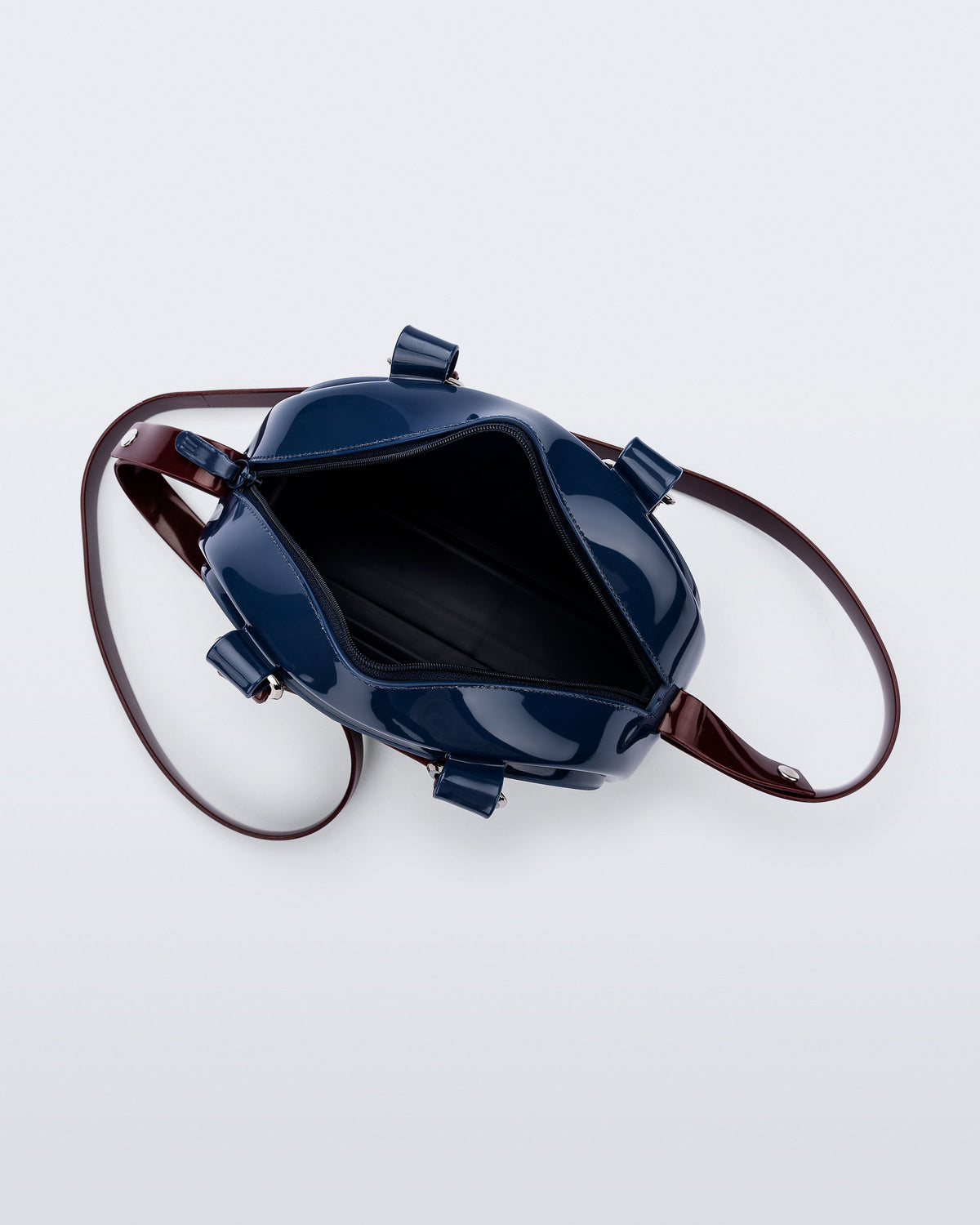 Top view of a blue Bowling bag with burgundy handle strap and cross body strap
