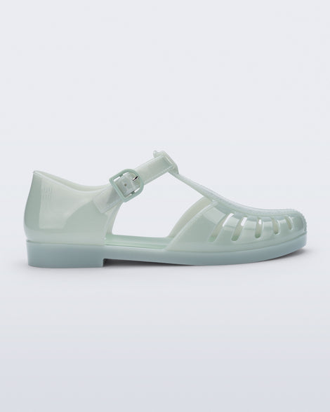 Side view of a milky green Aranha 79 flat with buckle
