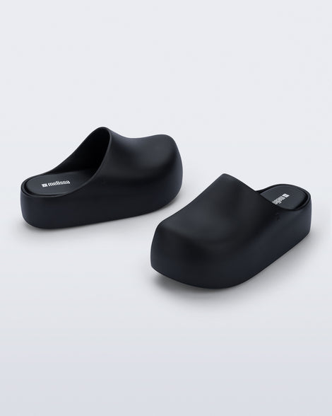 Side and angled view of a pair of black Free Clog Up Platforms