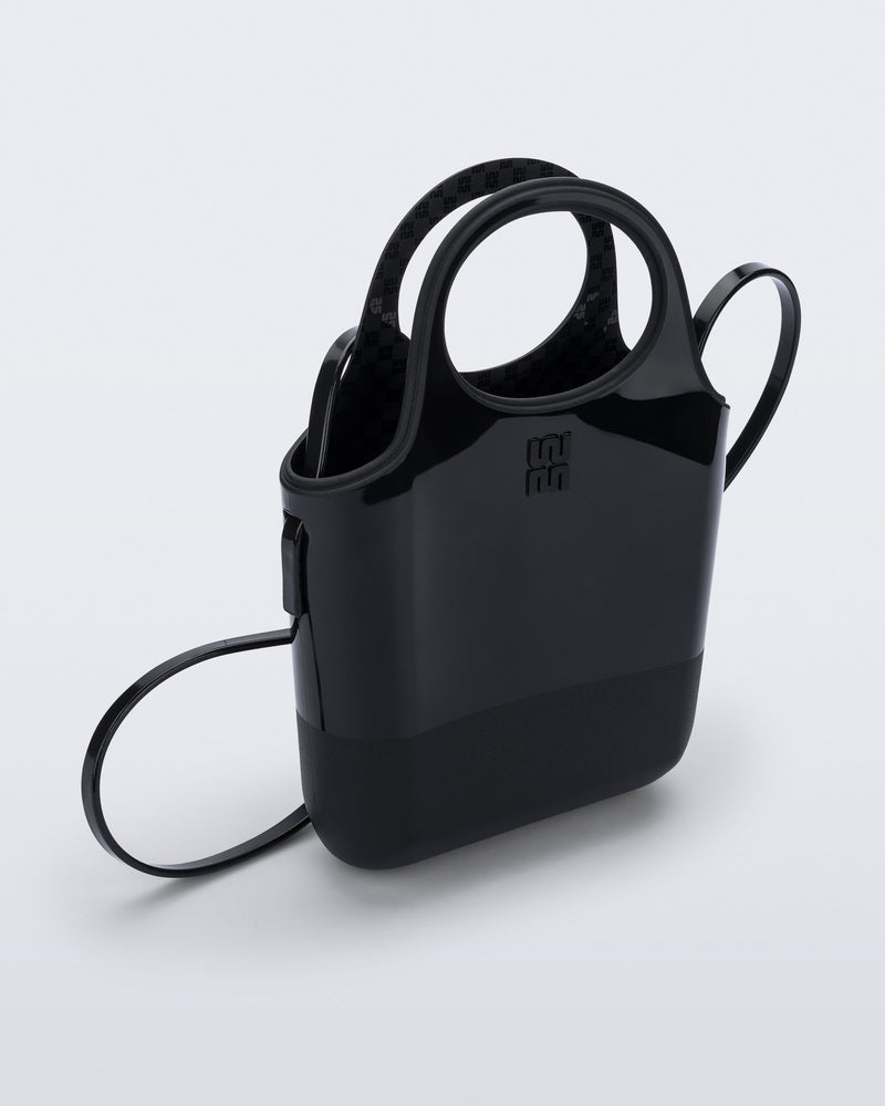 Angled view of a black Ultra Bag with handle and strap