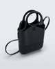 Angled view of a black Ultra Bag with handle and strap