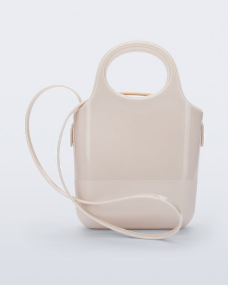 Side view of a beige Ultra Bag with handle and strap