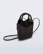 Angled view of a brown Ultra Bag with handle and strap