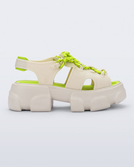 side view of a beige Camp platform sandal with neon green laces and accents