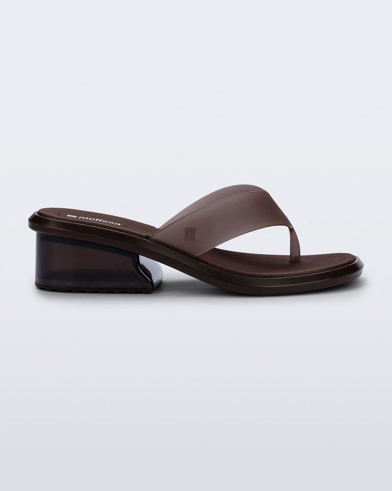 Side view of a brown Margot flip flop with low heel 