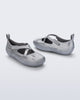 Back and angled view of a pair of silver Aira flats with top straps