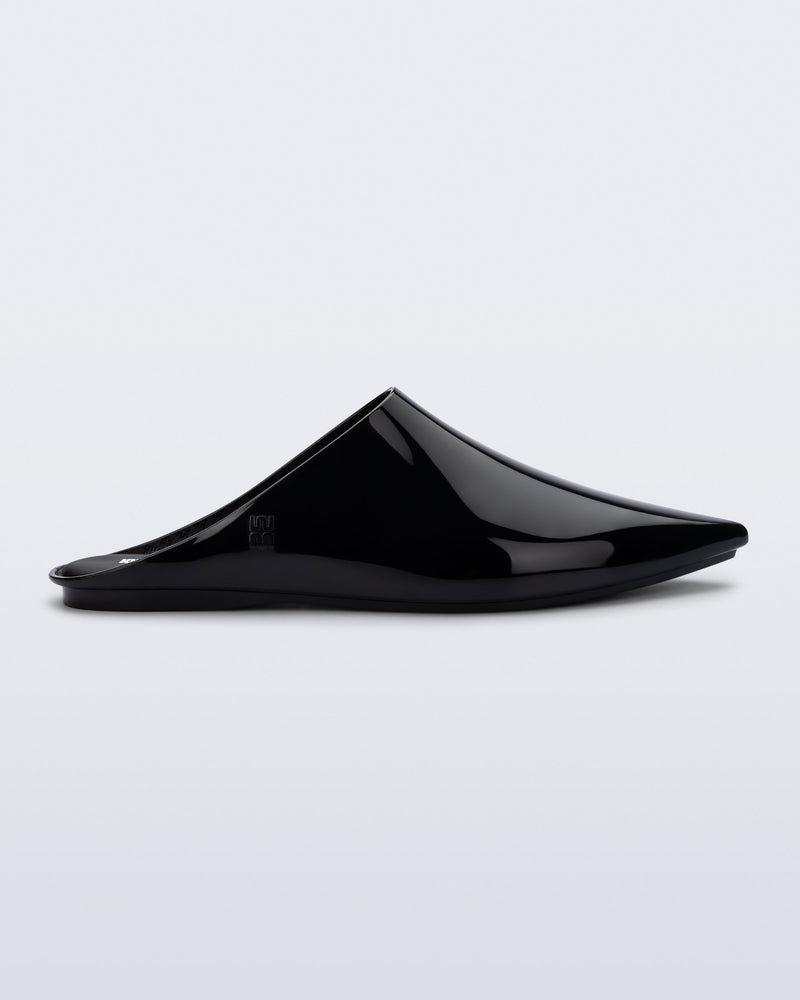 Side view of a black She slip on with pointed toe